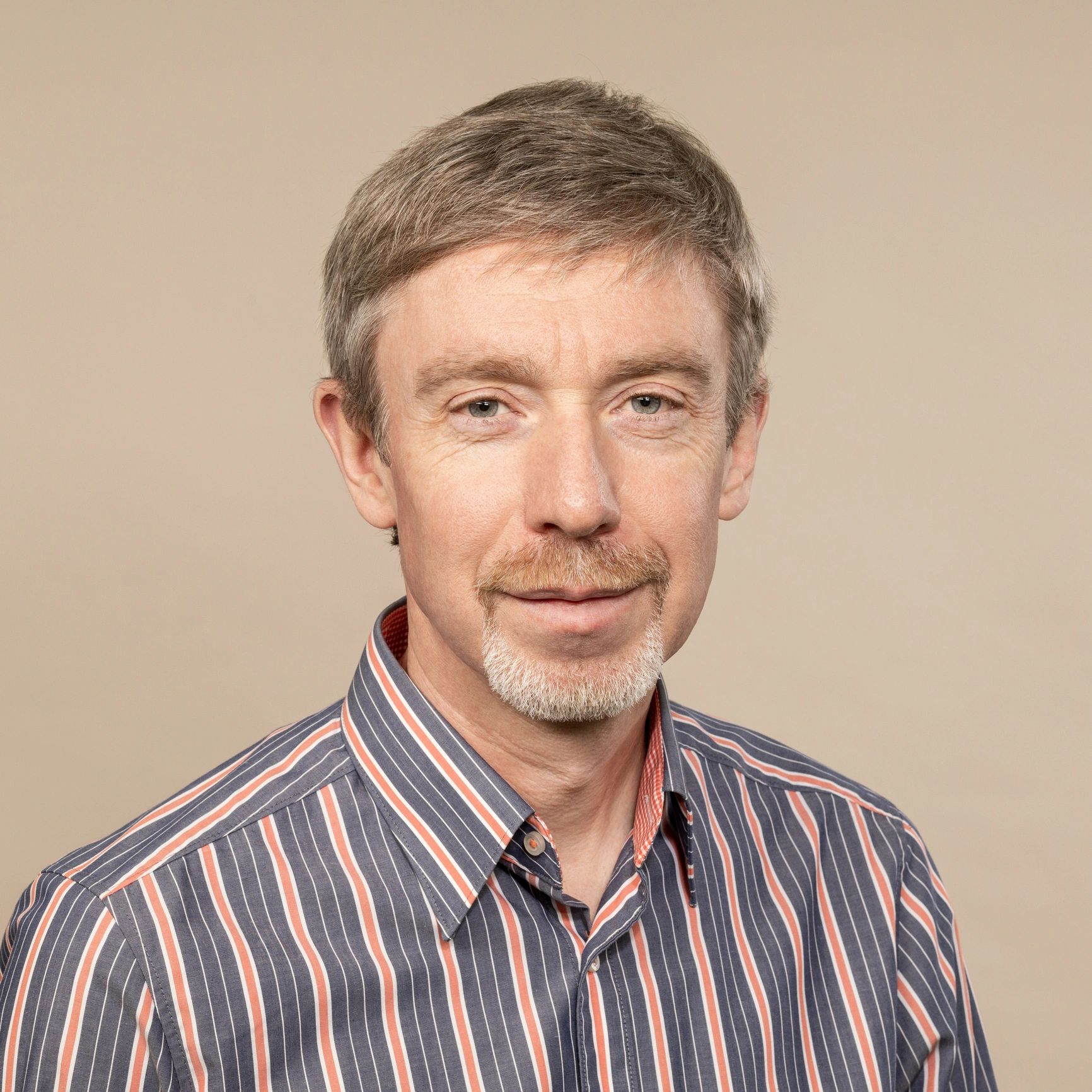 Portrait headshot of a professional with beard