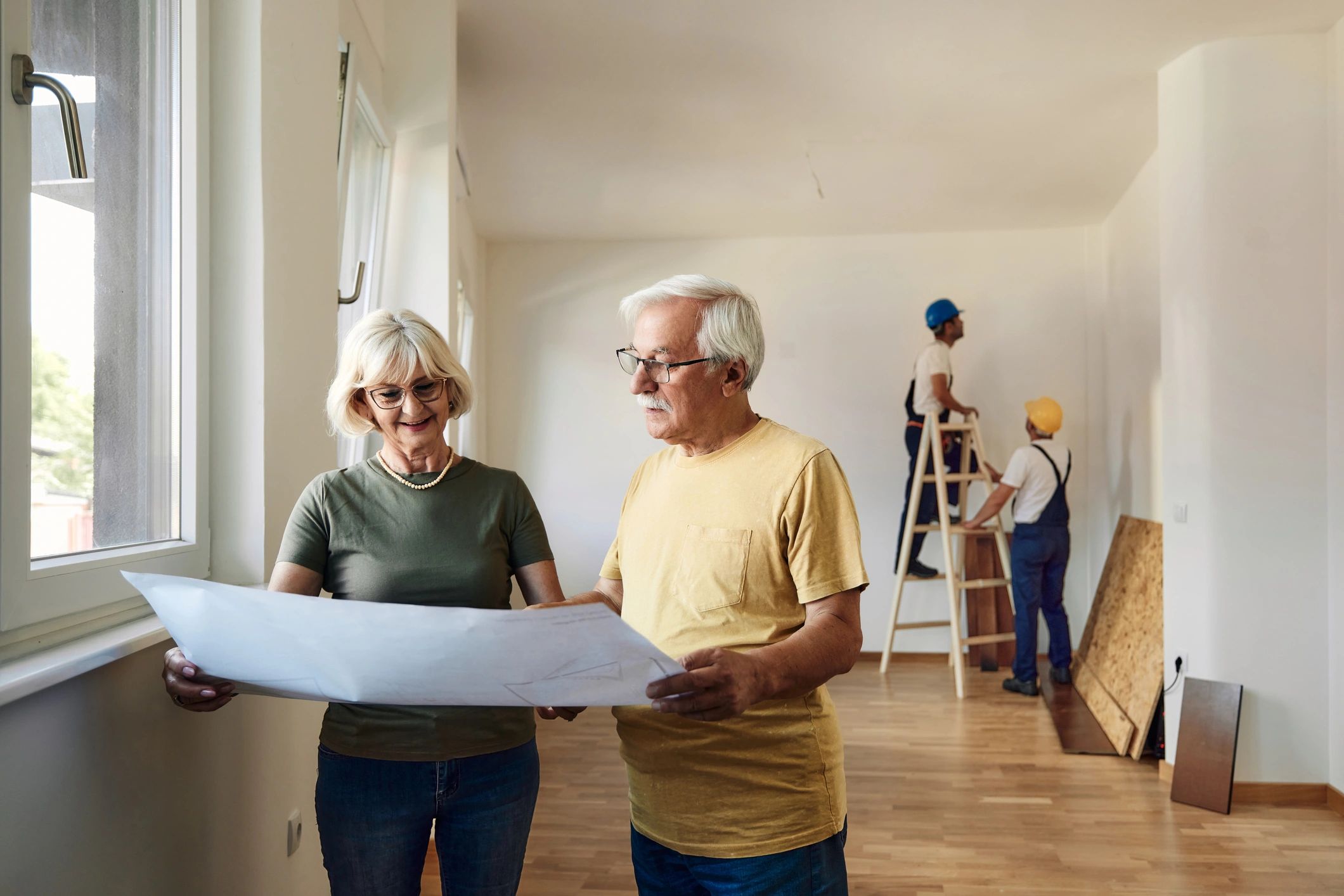Homeowners reviewing renovation plans together