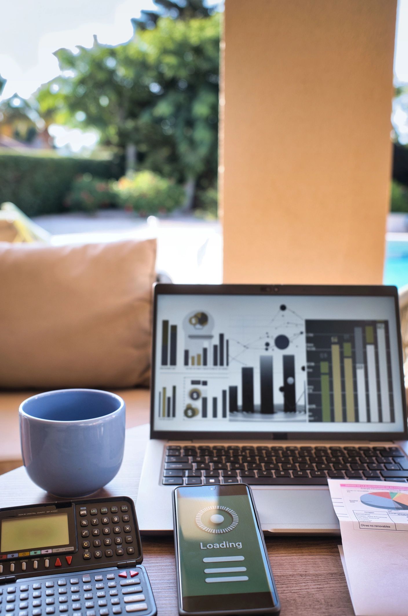Budget and invoice next to laptop and calculator
